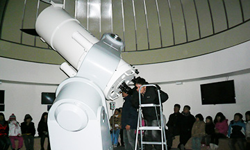 천체망원경을 보고 있는 모습